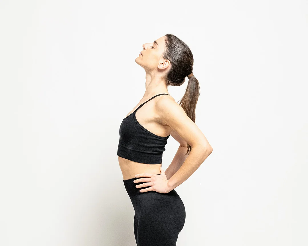 Patient holding the lower back, representing chronic lumbar spine pain and nerve irritation addressed by minimally invasive spine surgery (illustrative).