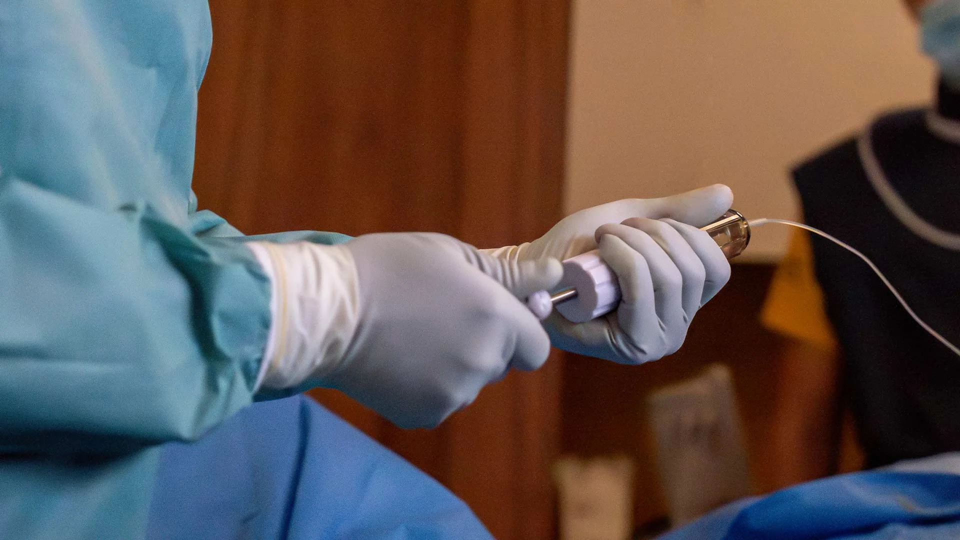 Image-guided vertebroplasty procedure using a needle to inject cement into a fractured vertebra (illustrative).